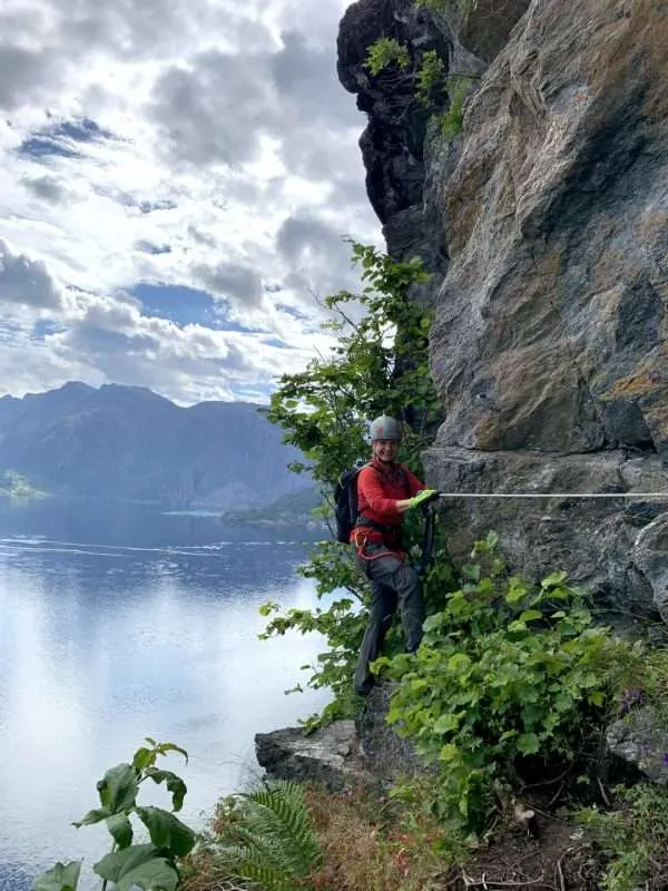 Woman on the edge of Mount Hornelen climbing